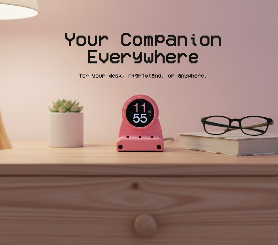 Pink DeskOrbie on a wooden surface with text about its versatility.