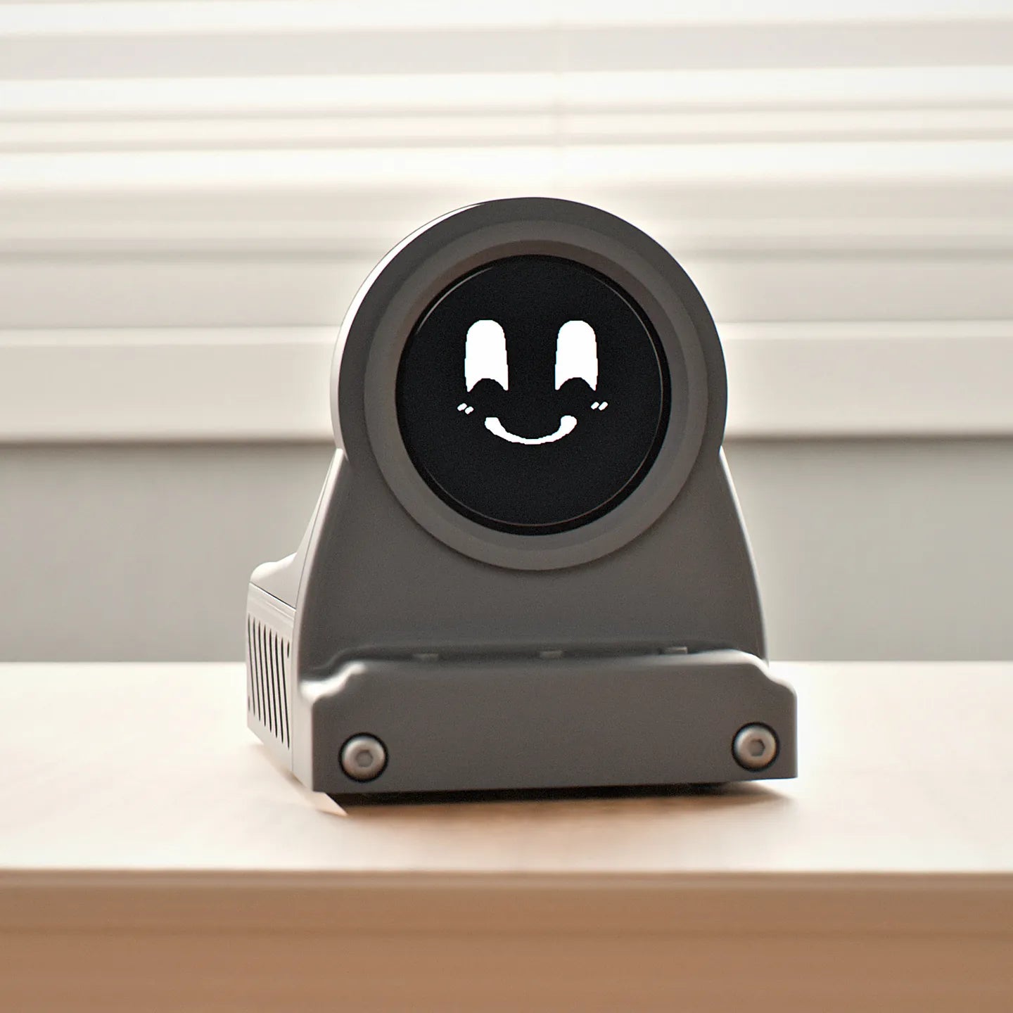 Charcoal Black DeskOrbie 2 with Orbie smiling on its screen