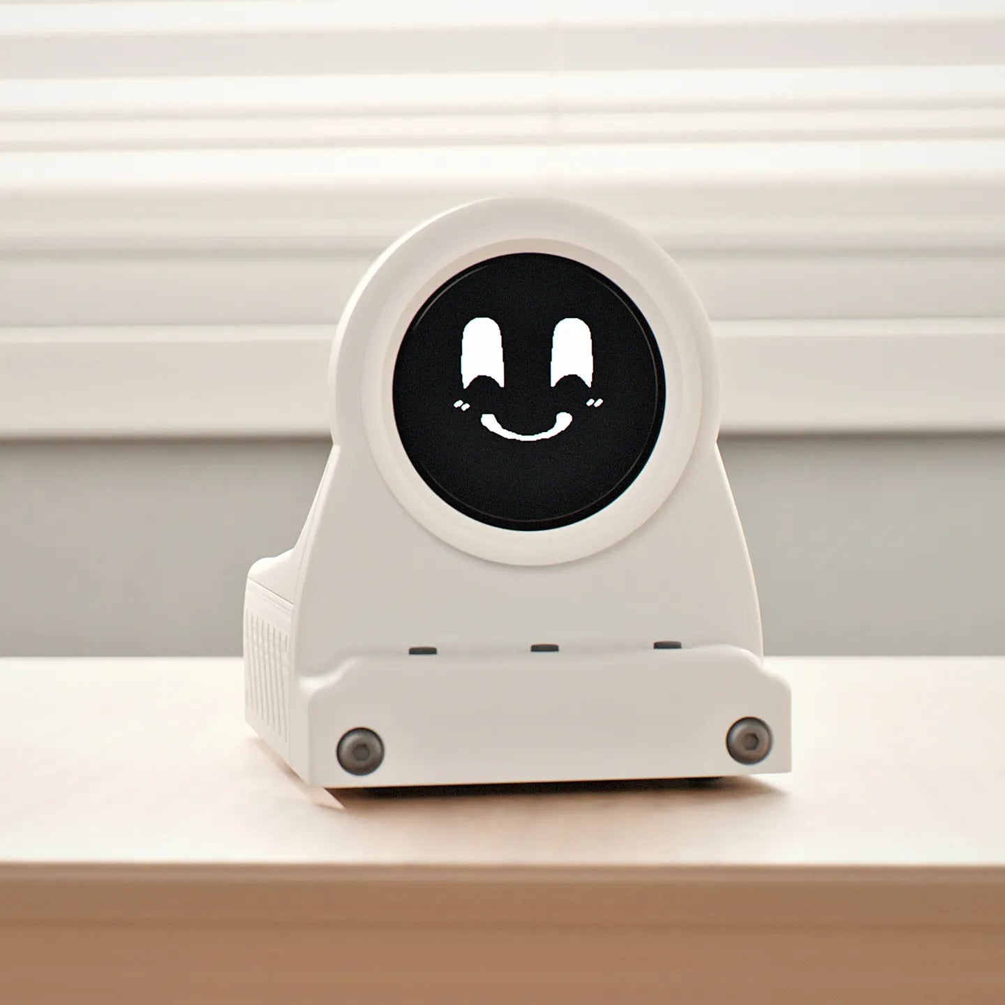 Frost White DeskOrbie 2 with Orbie smiling on its screen