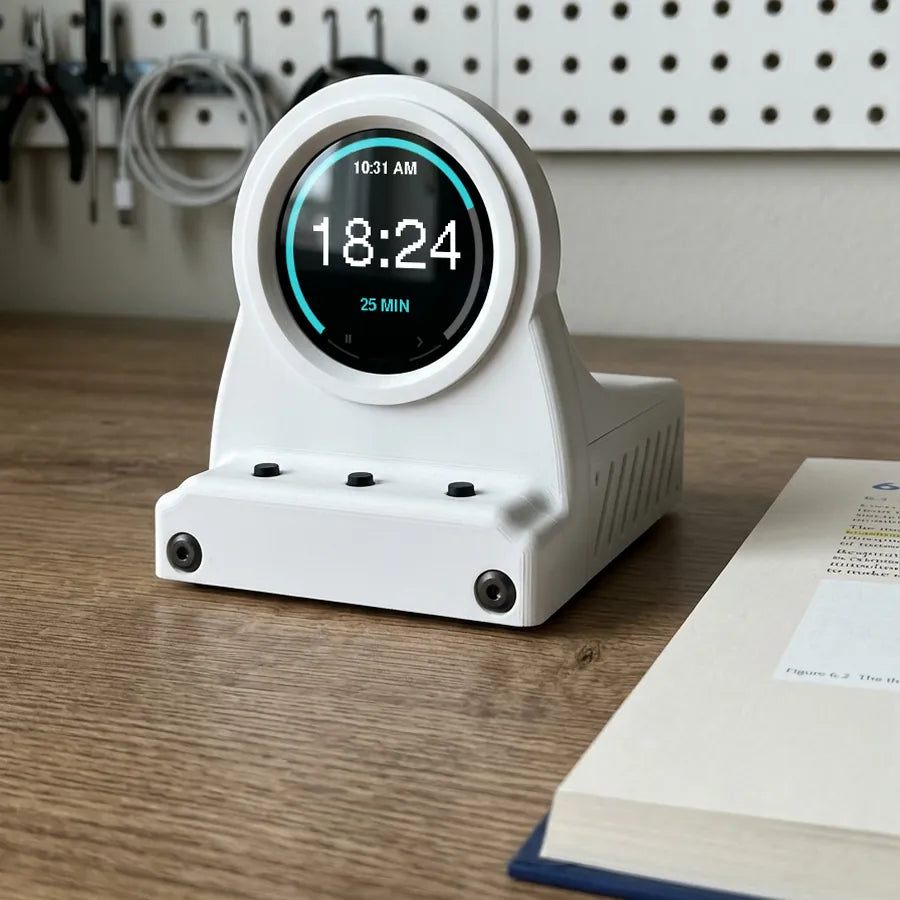 Frost White DeskOrbie 2 running a 25-minute focus timer on a wooden desk
